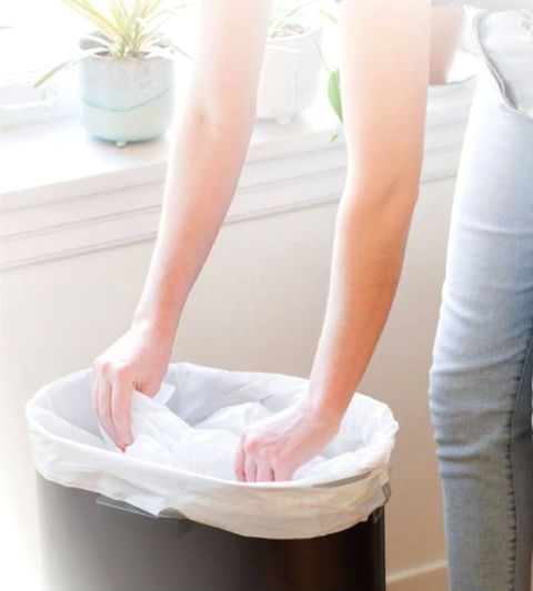 Barrier-bag-white-flat-larger-being-put-in-bin